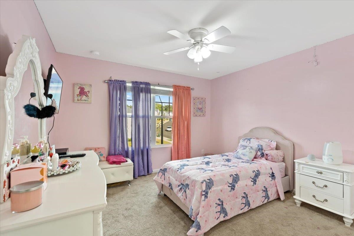 3537 Massey Ridge Court Raleigh, NC 27616 - Photo 34 of 41 a bedroom with a bed and a chandelier
