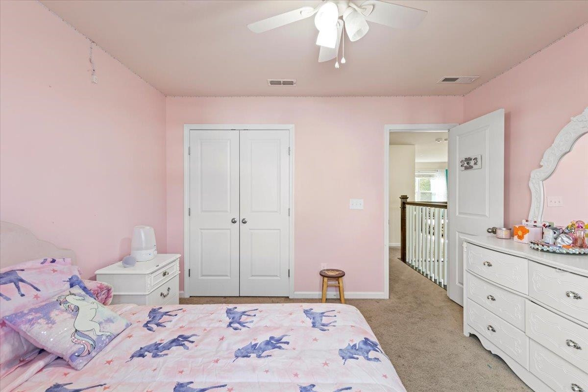 3537 Massey Ridge Court Raleigh, NC 27616 - Photo 35 of 41 a bedroom with a bed and a dresser in it