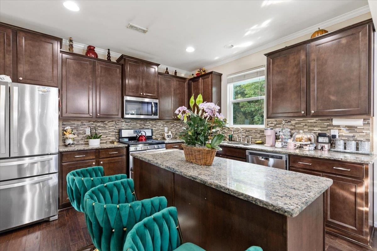 3537 Massey Ridge Court Raleigh, NC 27616 - Photo 10 of 41 a kitchen with granite countertop stainless steel appliances and wooden cabinets