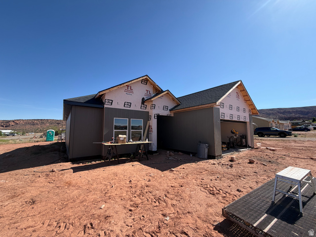 27 Lidia Circle Moab, UT 84532 - Photo 4 of 5 UNDER CONSTRUCTION residence featuring a dark shingle roof, siding, standing seam metal and a two-car garage