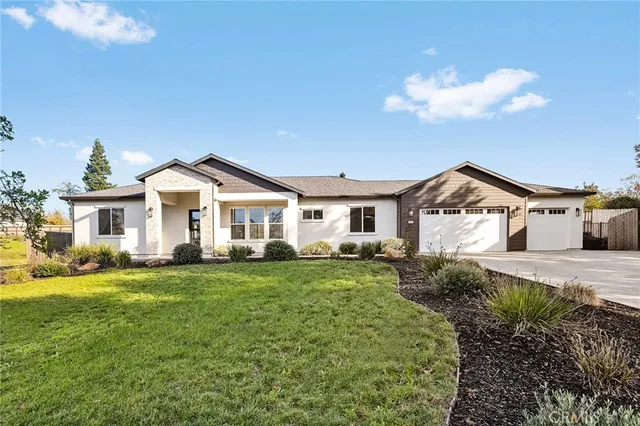 a front view of a house with a garden