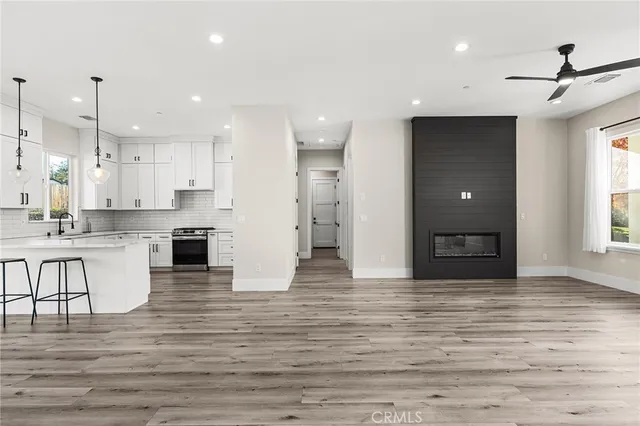 a view of kitchen with kitchen island wooden cabinets and refrigerator