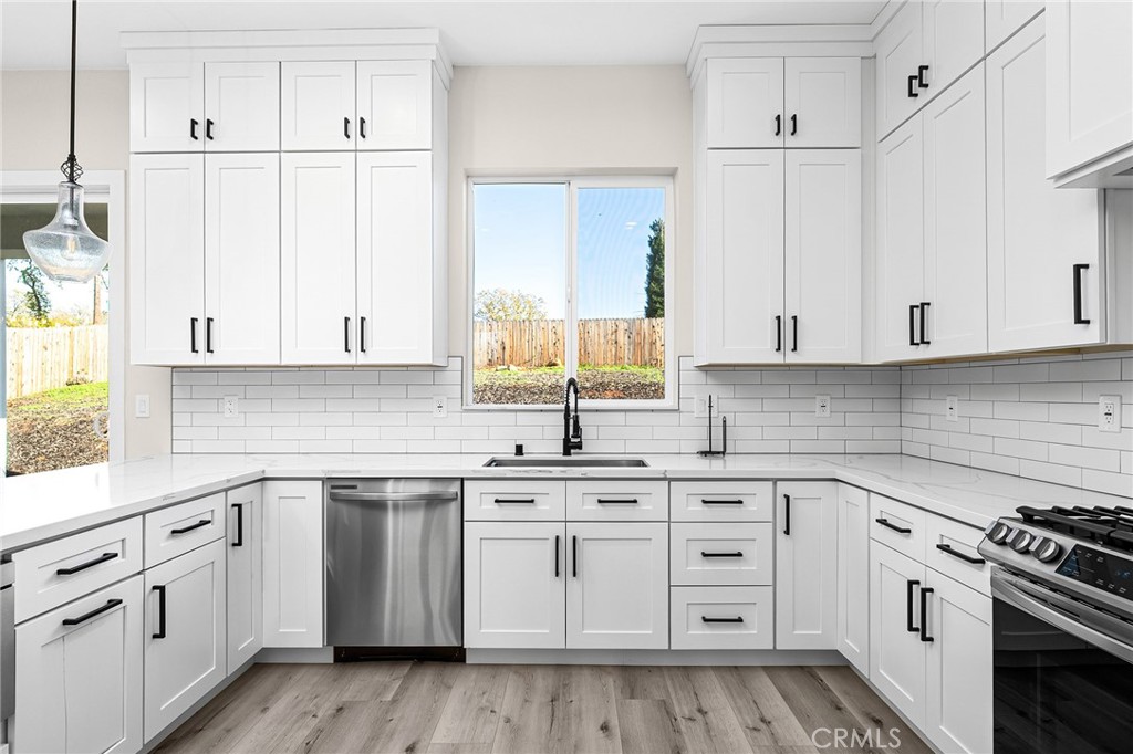 96 Valley View Drive Paradise, CA 95969 - Photo 18 of 47 a kitchen with white cabinets white stainless steel appliances and sink