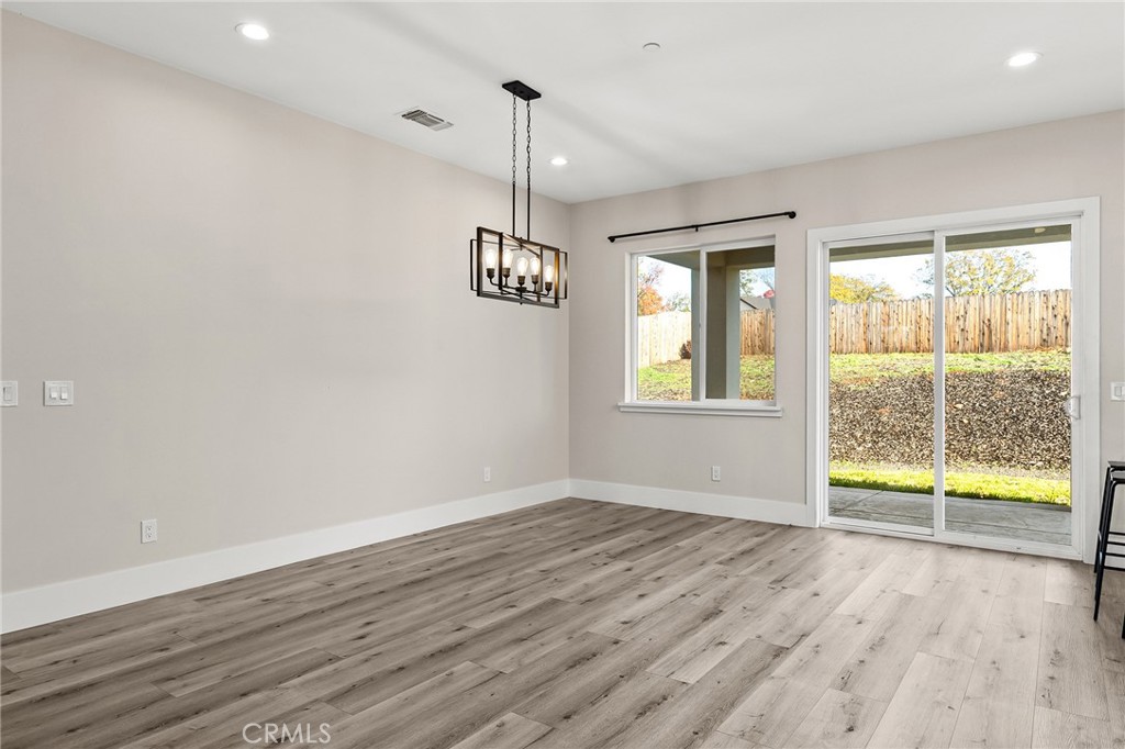 96 Valley View Drive Paradise, CA 95969 - Photo 20 of 47 a view of an empty room with a window and wooden floor