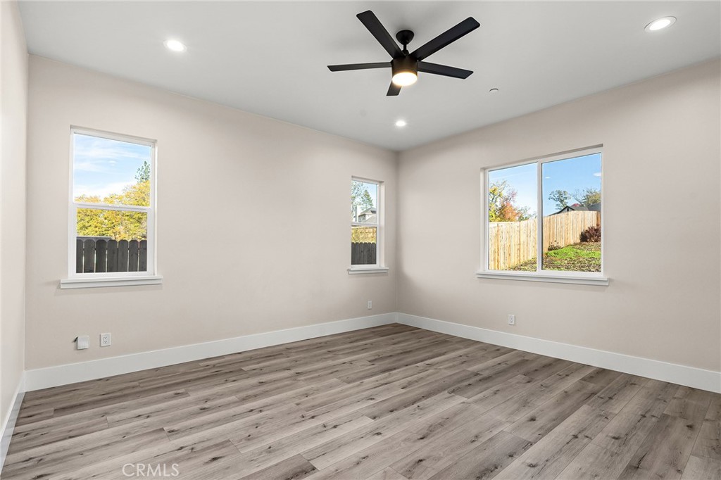 96 Valley View Drive Paradise, CA 95969 - Photo 24 of 47 a view of a big room with wooden floor and windows