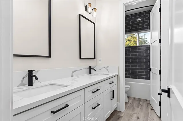 a bathroom with a sink a mirror and shower