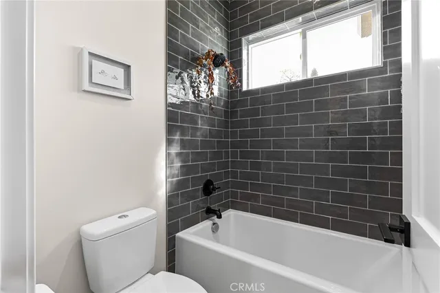 a bathroom with a toilet and bathtub