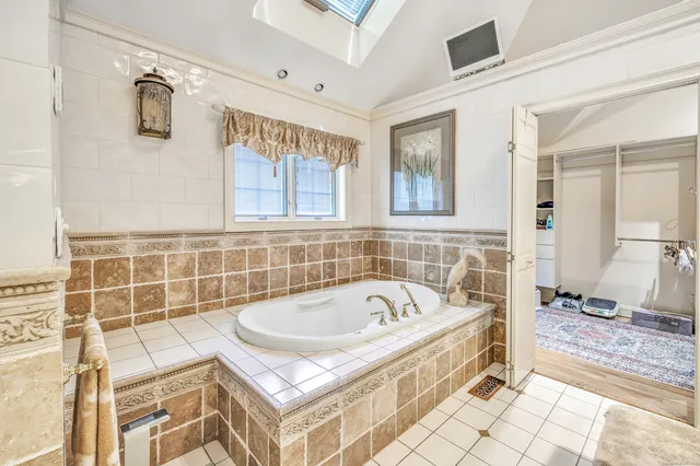 a bathroom with a bathtub and a shower
