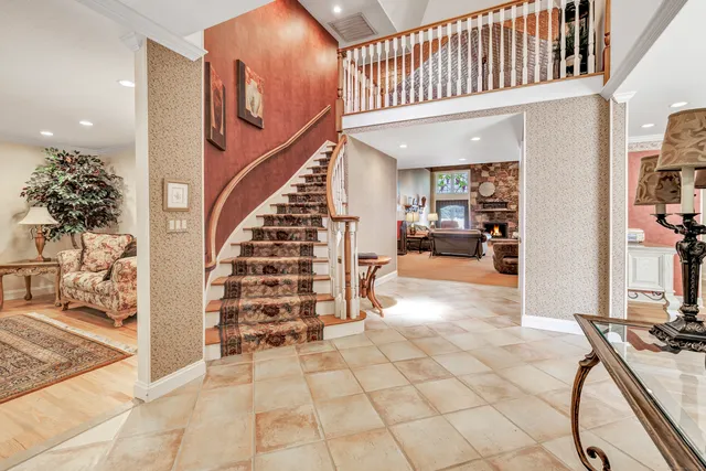 a view of a livingroom with furniture and stairs