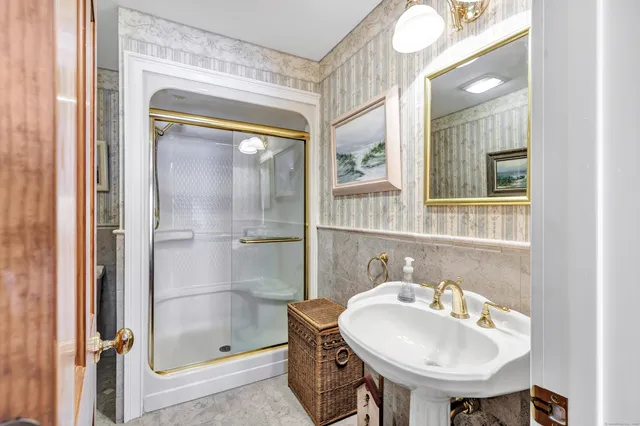 a bathroom with a sink a mirror and a shower