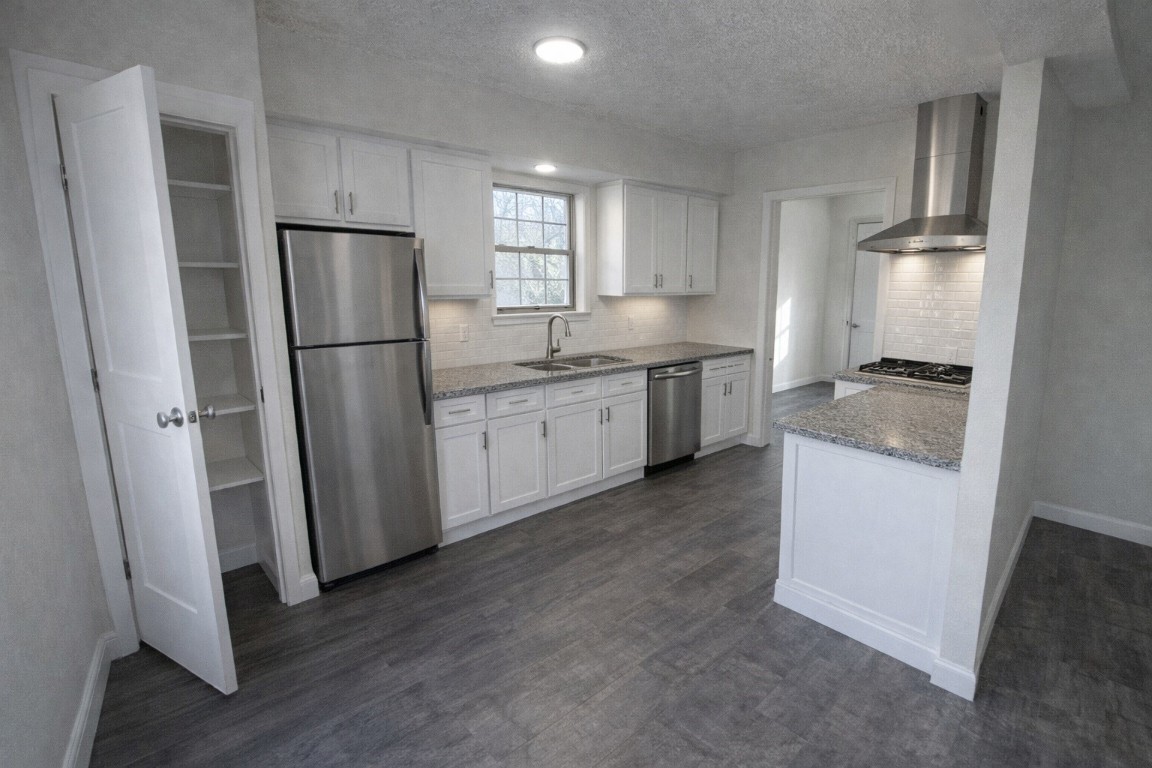 5423 Grace Point Lane Houston, TX 77048 - Photo 2 of 6 a kitchen with a refrigerator sink stove and cabinets