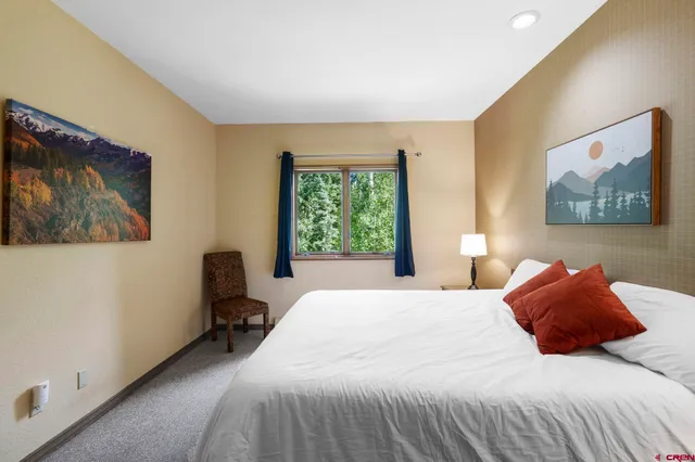 a bedroom with a bed and chair