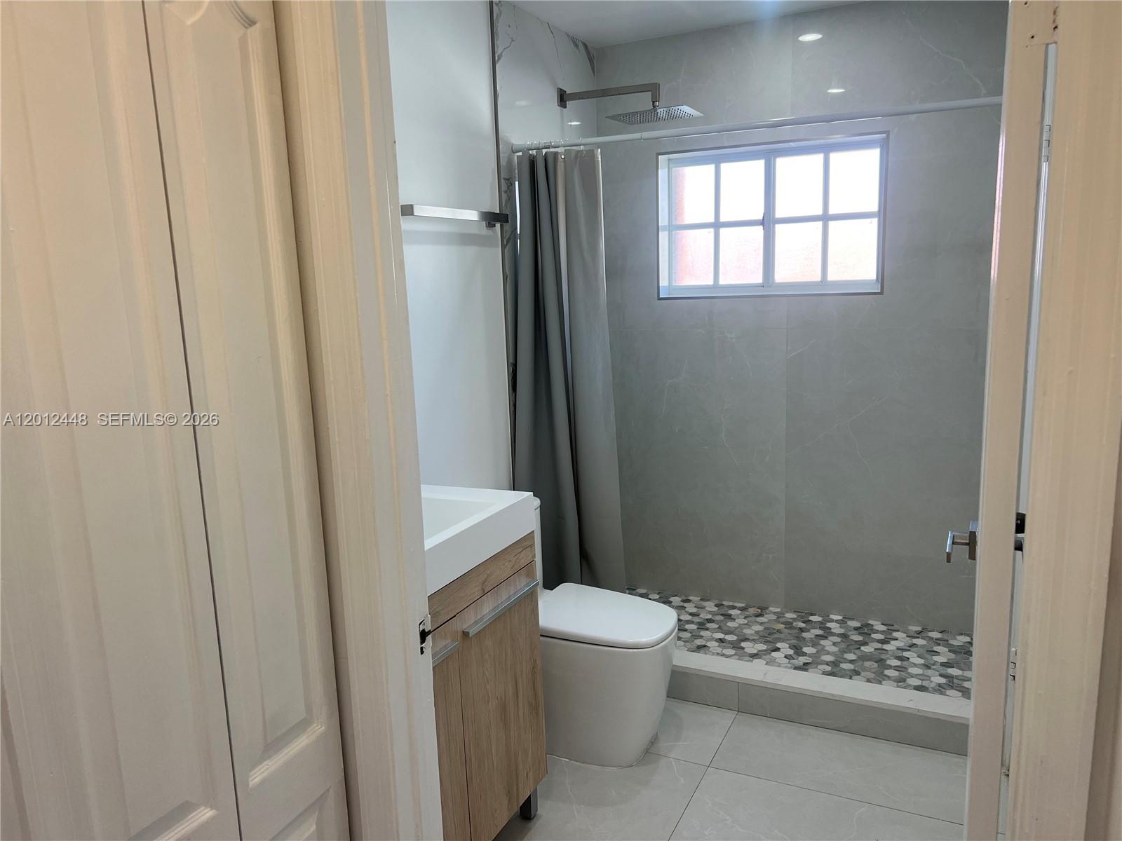 2425 West 76th Street, Unit 207 Hialeah, FL 33016 - Photo 4 of 11 a bathroom with a toilet and a shower