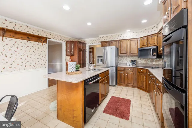 a living room with furniture and kitchen view
