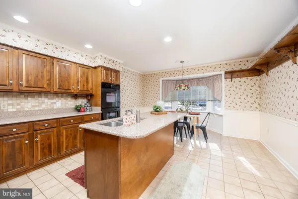 a dining room with furniture a chandelier and wooden floor