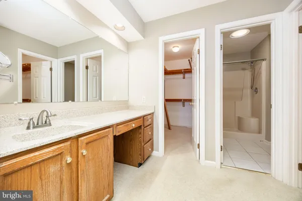 a spacious bathroom with a sink and a mirror