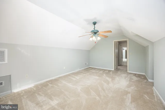 a front view of a house with a yard covered with snow