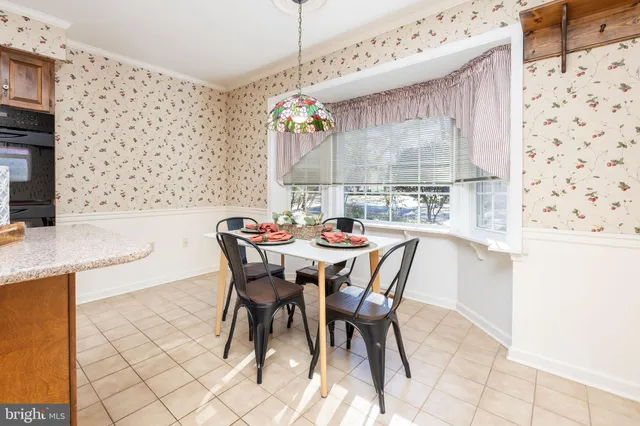 a dining area with a table and chairs