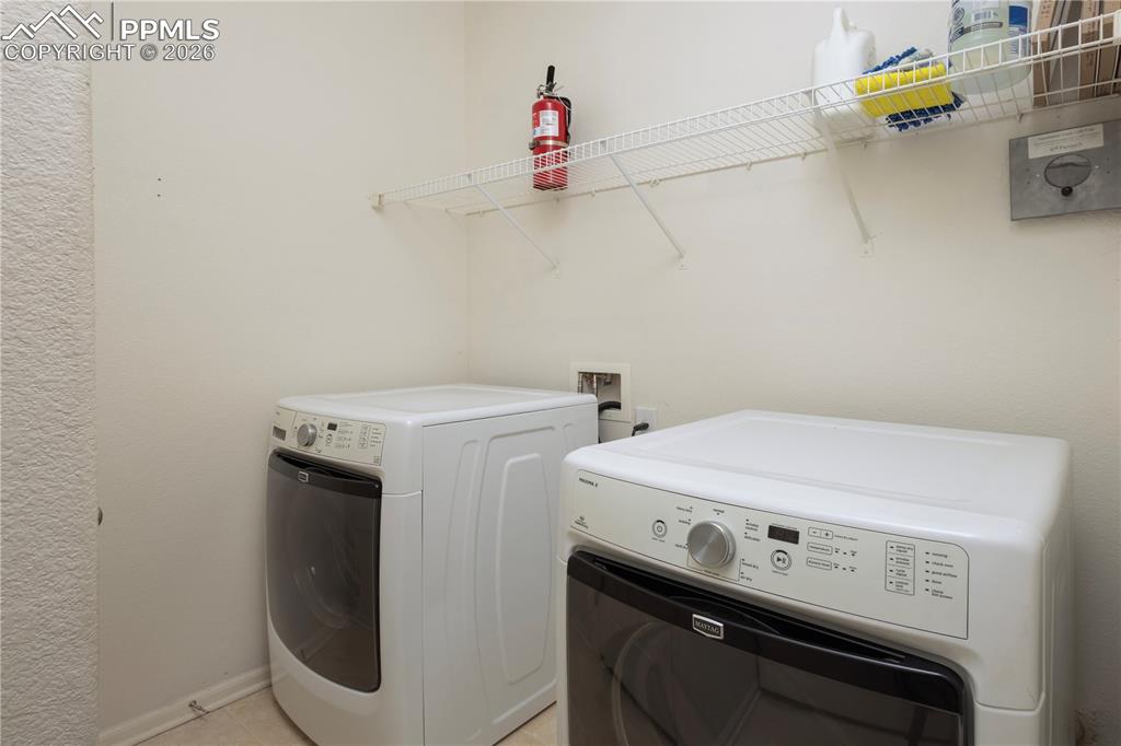 4815 Harrier Ridge Drive Colorado Springs, CO 80916 - Photo 19 of 33 Laundry area with washing machine and dryer and baseboards