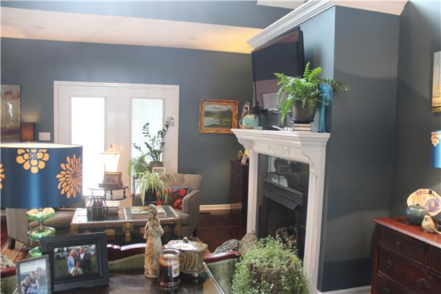 3700 Pondywood Road Adams, TN 37010 - Photo 5 of 20 Another view of the living area. The fireplace adds a touch of class! The French doors walk out onto a beautiful deck where you can enjoy watching the kids in the pool this summer. This home offers privacy on a large 7.5 acre lot.