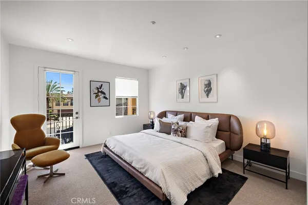 a bedroom with bed and a chair