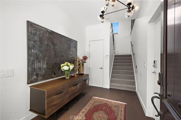 a living room with furniture a wooden floor and next to a window