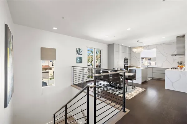 a kitchen that has a lot of cabinets in it and wooden floors