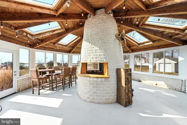 a living room with furniture a fireplace and a chandelier
