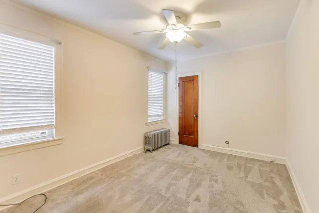 a view of a hallway with furniture and chandelier