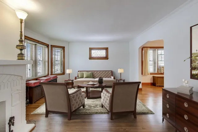 a living room with a fireplace furniture and a wooden floor