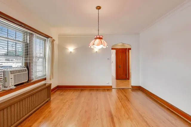 a kitchen with stainless steel appliances granite countertop a stove a sink and a refrigerator with wooden floor