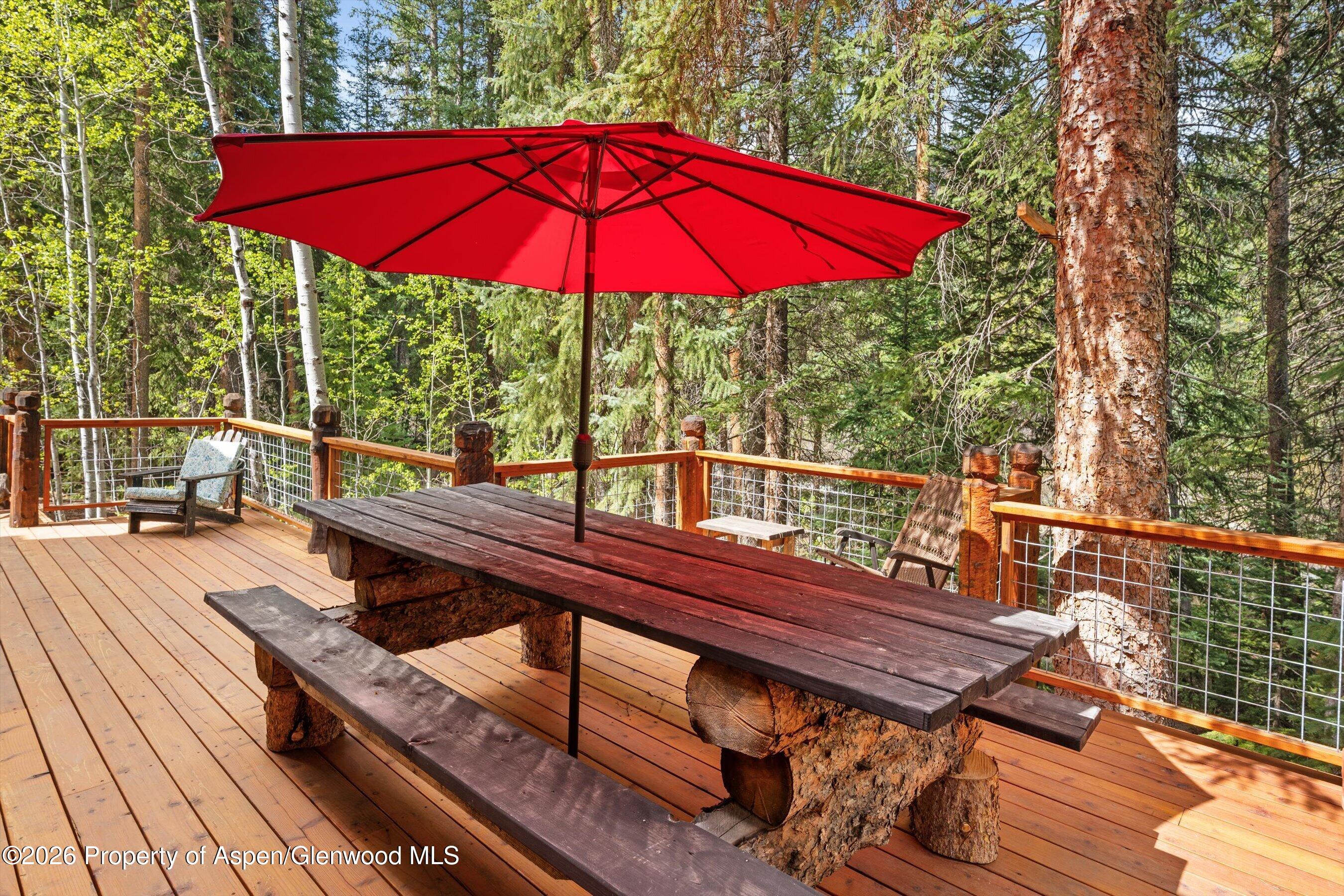 26608 Frying Pan Road Meredith, CO 81642 - Photo 11 of 49 a view of a deck with furniture and umbrella