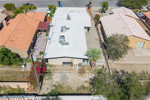 an aerial view of a house with a yard and sitting area
