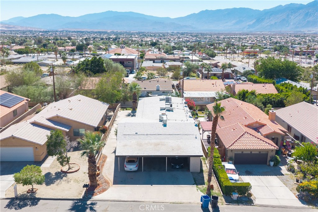 12700 Parma Drive Desert Hot Springs, CA 92240 - Photo 10 of 20 an aerial view of a house with a garden and lake view