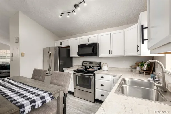 a kitchen that has a sink and a stove top oven