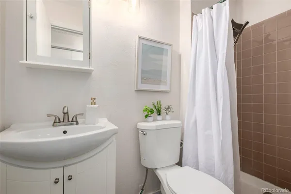 a bathroom with a sink a toilet and mirror