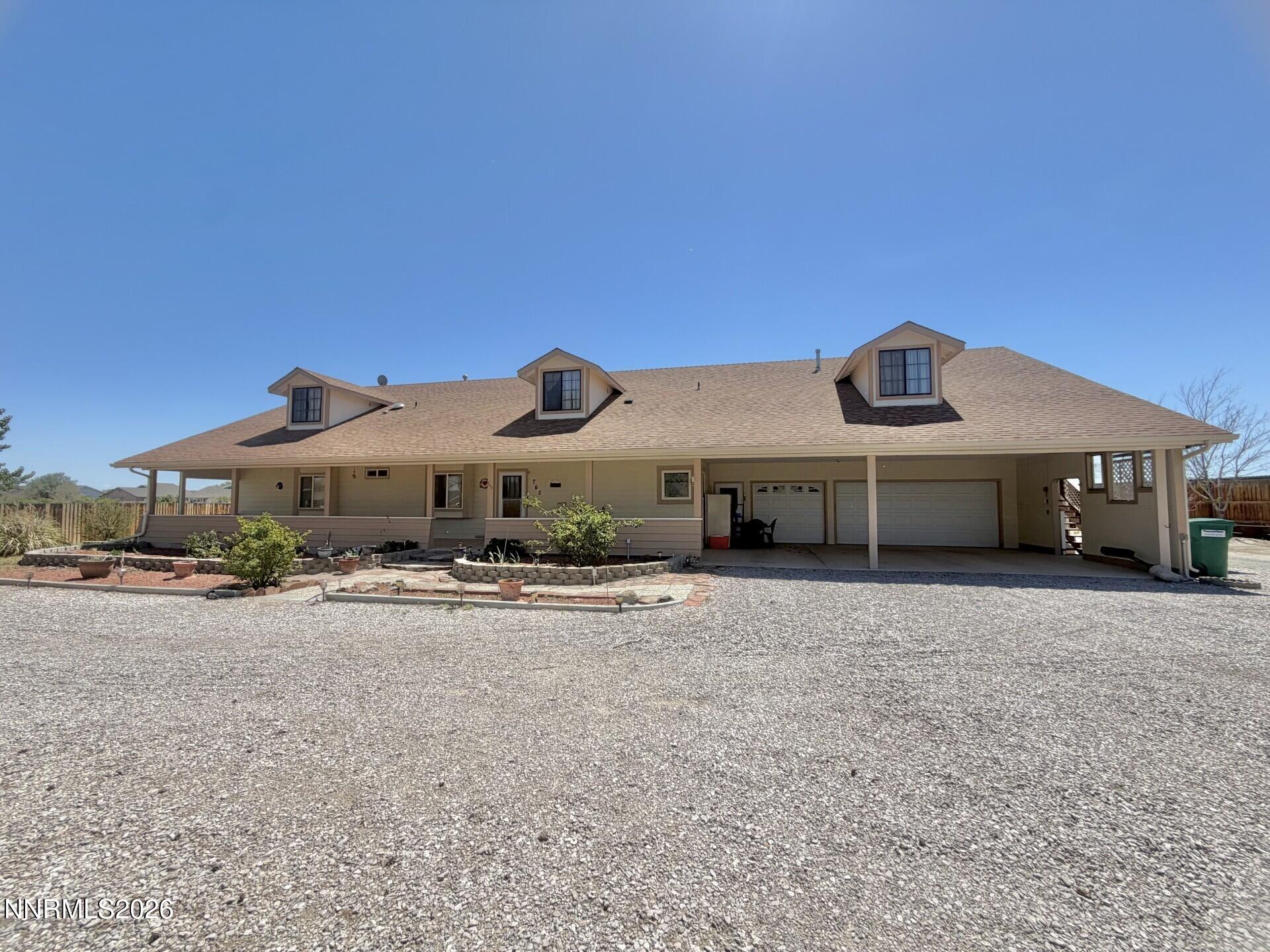 765 Hunter Park Way Fallon, NV 89406 - Photo 1 of 30 a front view of a house with a yard and garage