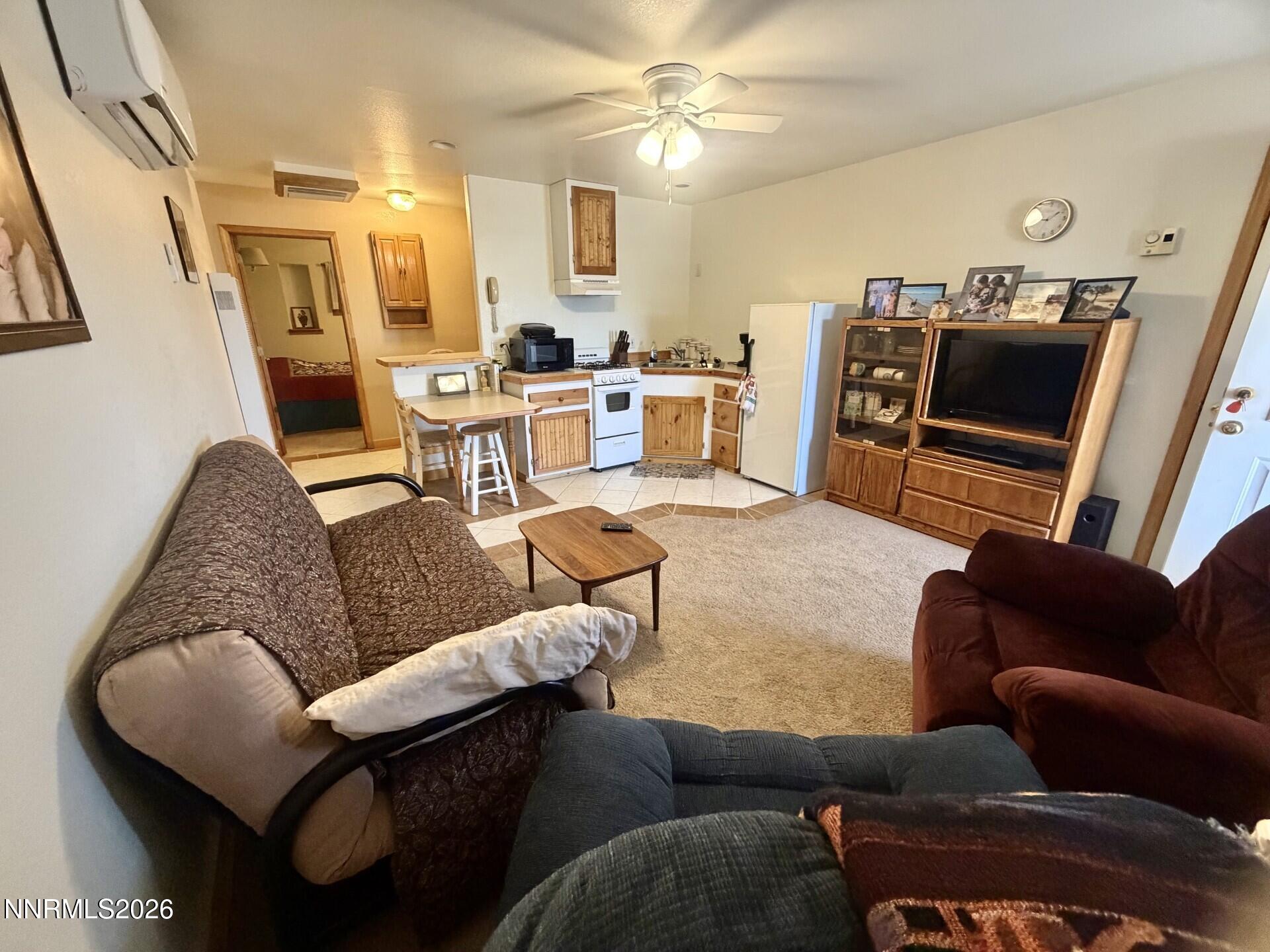 765 Hunter Park Way Fallon, NV 89406 - Photo 20 of 30 a living room with furniture and a flat screen tv