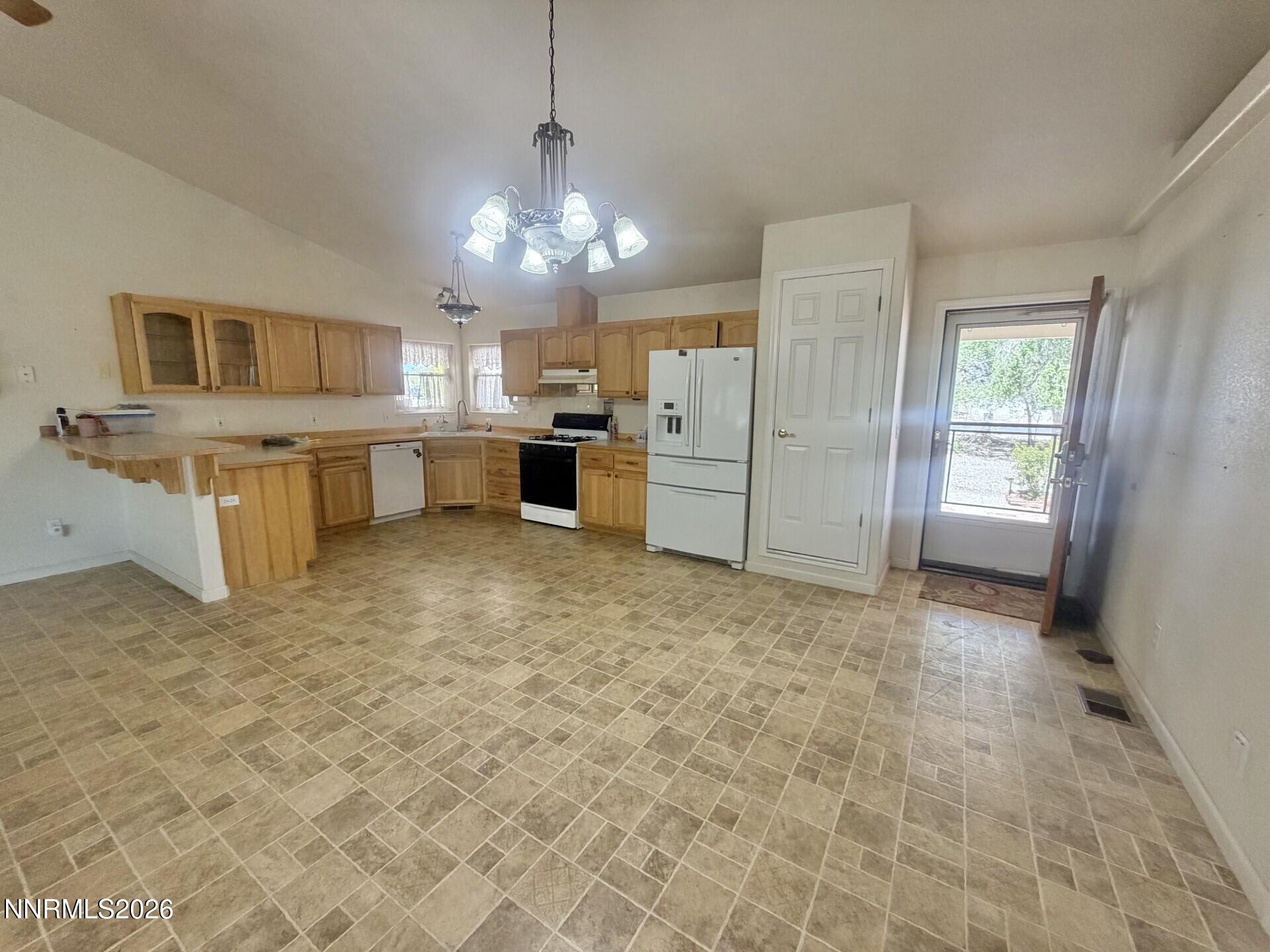 765 Hunter Park Way Fallon, NV 89406 - Photo 4 of 30 a view of a kitchen with refrigerator and cabinets