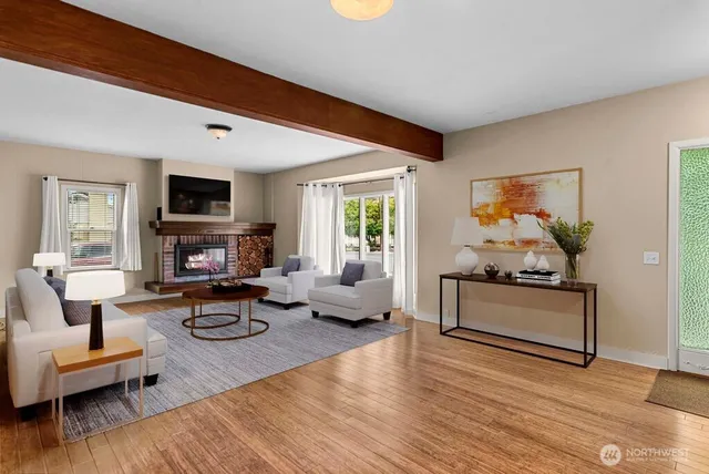 a living room with furniture a fireplace and a flat screen tv
