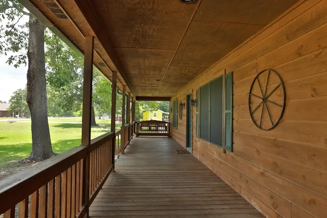 a view of a porch with wooden floor and outdoor space
