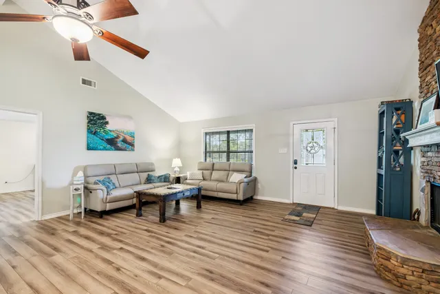 a living room with furniture and a wooden floor