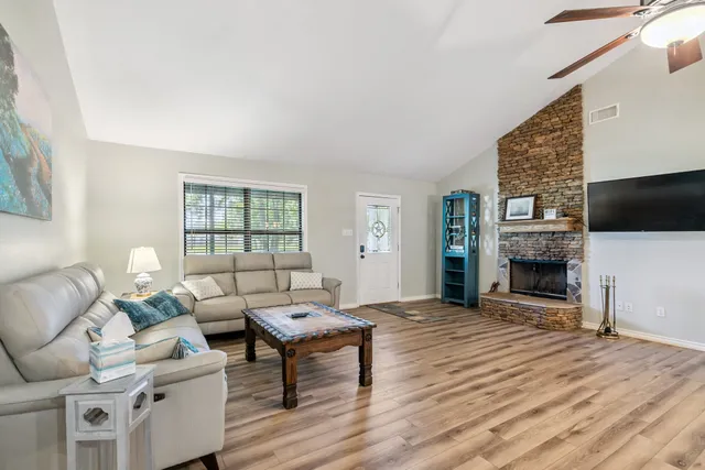 a living room with fireplace furniture and a flat screen tv
