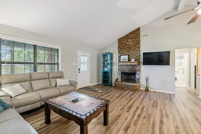 a living room with furniture and a fireplace