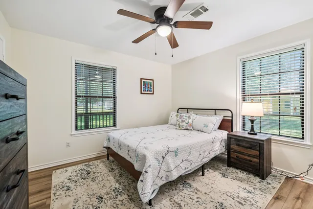 a bedroom with a large bed and a window