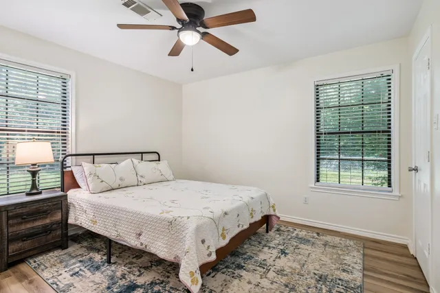 a bedroom with a large bed and a window