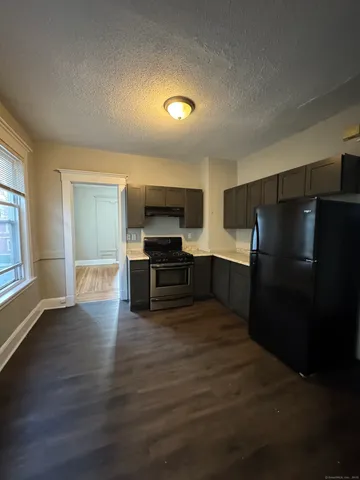 a kitchen with stainless steel appliances a refrigerator and a stove top oven