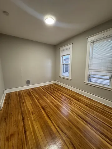 a view of a room with wooden floor and window