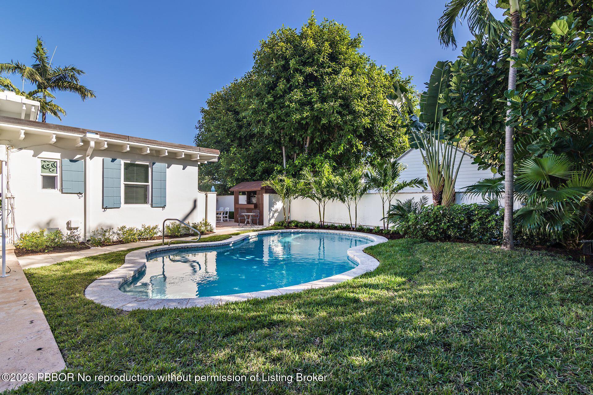 224 Churchill Road West Palm Beach, FL 33405 - Photo 20 of 33 a view of a house with swimming pool and sitting area