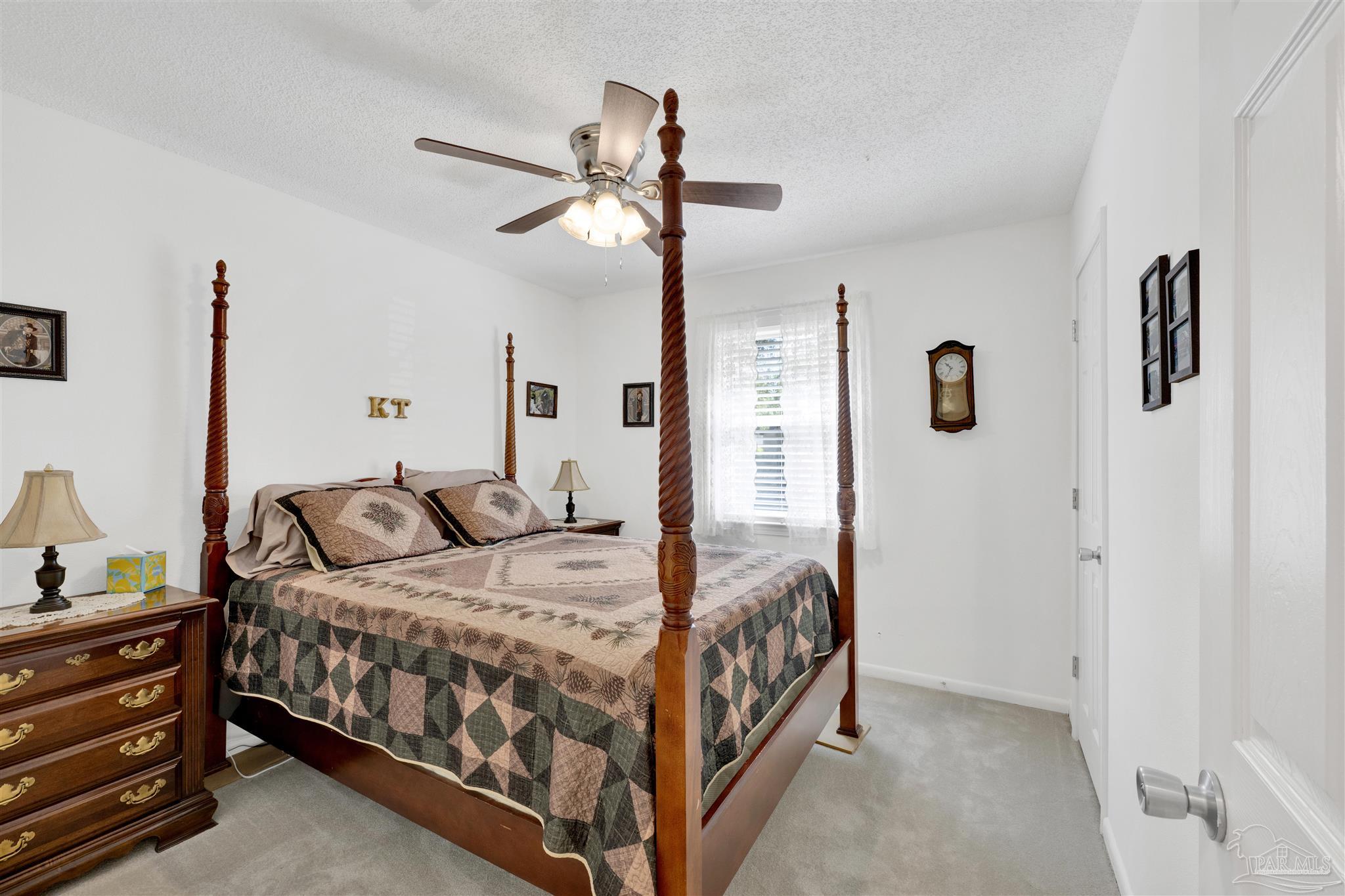5131 Oakleaf Drive Pace, FL 32571 - Photo 11 of 23 a bedroom with a bed and ceiling fan